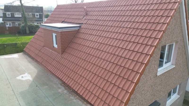 A freshly coated terracotta roof in clean, uniform condition